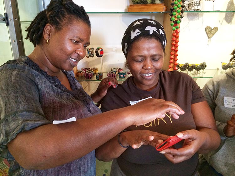The heART of a Woman Project mobile photographers at eKhaya eKasi in Khayelitsha, South Africa learn "pinching" on the iPhone.